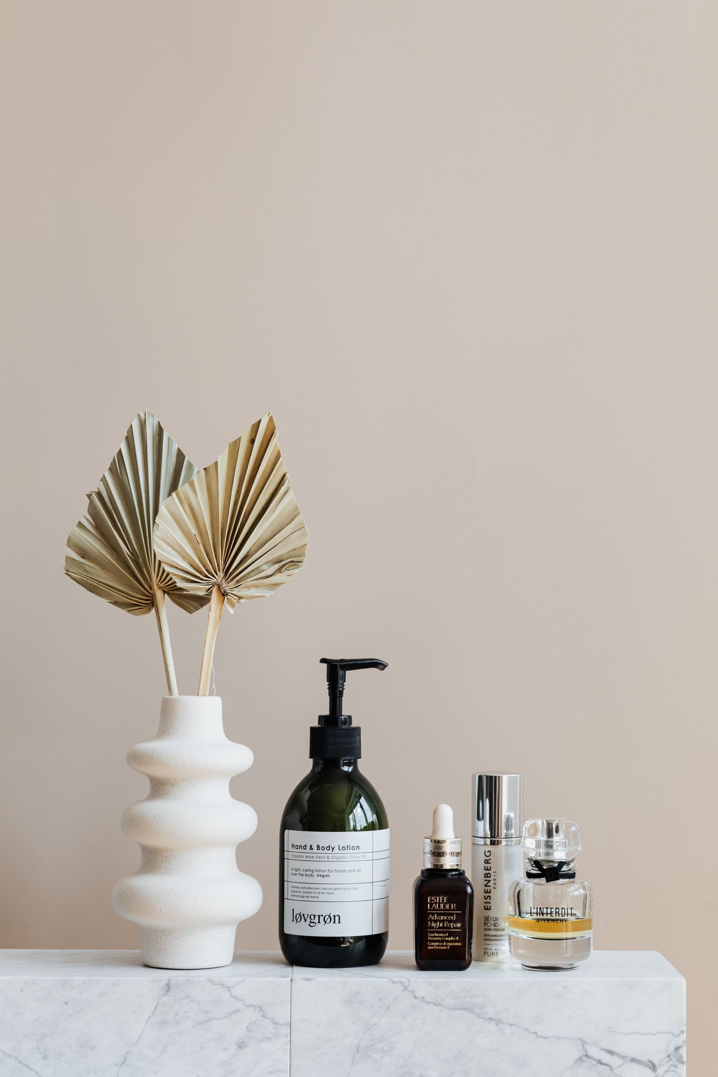 Serums and moisturizers on a soft surface