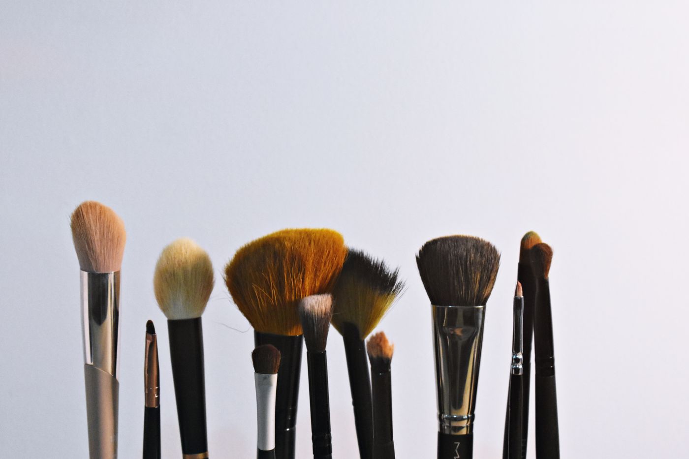 A set of makeup brushes in a holder